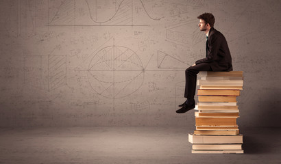 Businessman sitting on books