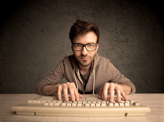 Computer geek typing on keyboard