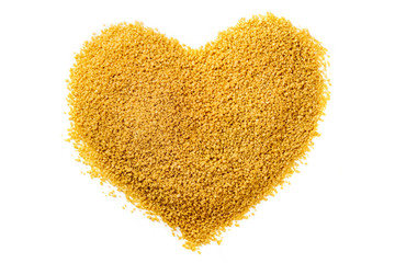 Heart made of couscous, shot from above on white