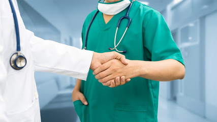 Doctors shaking hands. Medical people teamwork.