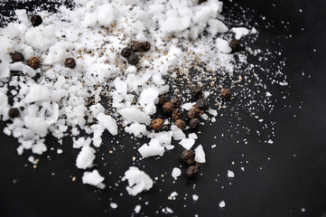Ingredients Sea Salt and Black Pepper on Black Background