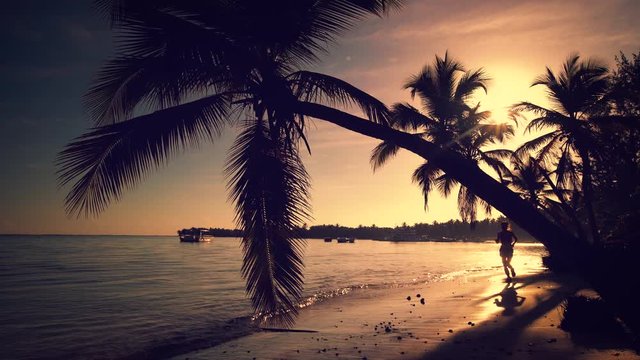 Sea sunrise video. Girl running on the tropical island beach Punta Cana