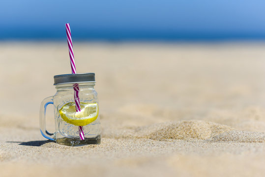 Lukecin, Poland, June 15, 2017: Cold drink in jar on the beach with copy space.