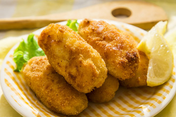Croquettes with lemon on the plate