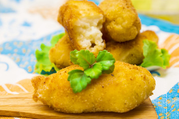 Croquettes on plate on colorful tablecloth