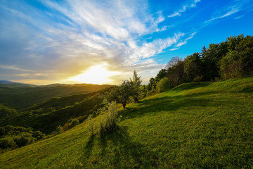 Evening and sunset on mountain hills of a romanian village - obrazy, fototapety, plakaty