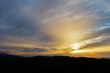 Fototapeta na wymiar Evening and sunset on mountain hills of a romanian village