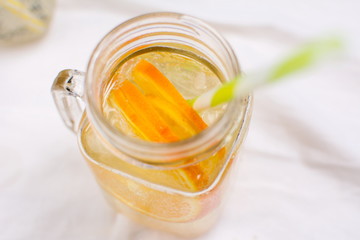 Water with orange and lemon in glass jar