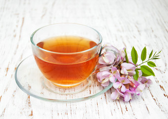 Cup of tea with acacia flowers