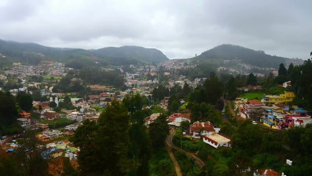 Ooty, India. Nilgiri mountains in Ooty, South India. View of the picturesque valley during the cloudy day. Beautiful houses and hotels. Very green touristic area. Time-lapse during the rain
