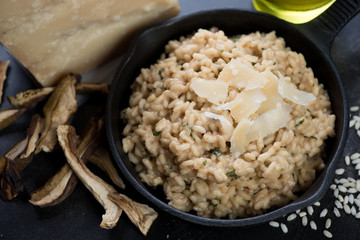 Risotto with cep boletus topped with parmesan cheese, closeup, horizontal shot