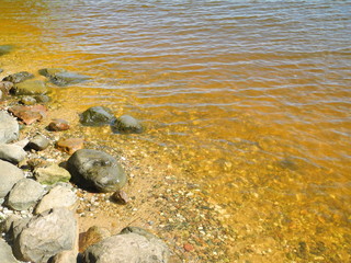 a riverbank with stones in Sunny weather
