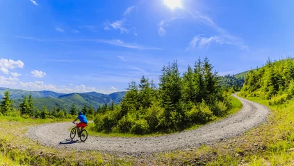 Plexiglas foto achterwand Mountain biker riding on bike in summer mountains forest landscape. Man cycling MTB outdoor sport activity. © Gorilla