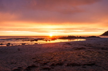 Sunset with a beach and a group of photographers - Lofoten, Norway.