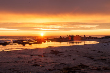 Naklejka premium Sunset with a beach and a group of photographers - Lofoten, Norway.