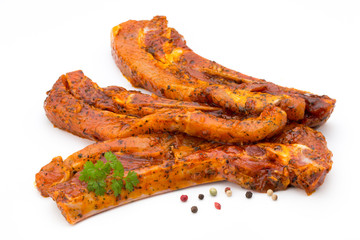 Spicy marinated spare ribs barbecued on the white background.