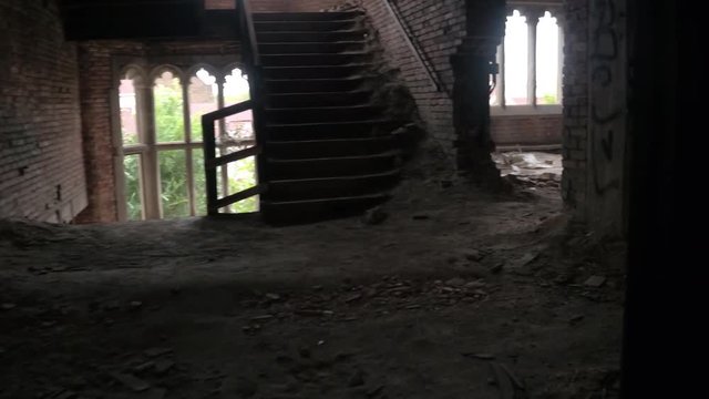 CLOSE UP: Exploring scary dark rooms and corridors in abandoned crumbling City Methodist Church, Gary Indiana. Majestic brick fortress in decline falling apart. Debris & destruction in old hotel