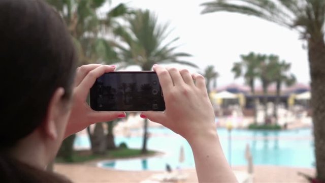 High quality video of woman taking a picture by the mobile phone in real 1080p slow motion 250fps