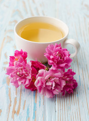 Fragrant hot tea roses on a wooden background