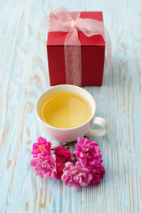 Fragrant hot tea roses on a wooden background