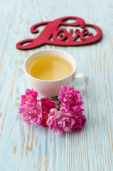 Fragrant hot tea roses on a wooden background