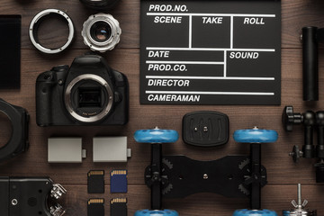 Fototapeta premium different video making equipment for indie production on brown wooden table view from above. short movie production essentials