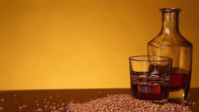Whiskey or bourbon or skotch and corn on the table. camera movement from left to right