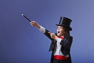 Young magician performing with a magic wand
