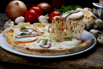 Slice of pizza raised