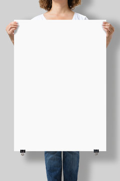 Woman Holding A Blank A1 Poster Mockup Isolated On A Gray Background.