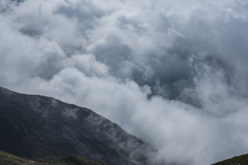 Fototapeta na wymiar Low clouds on the mountain peaks, Kazakhstan, Kyrgyzstan