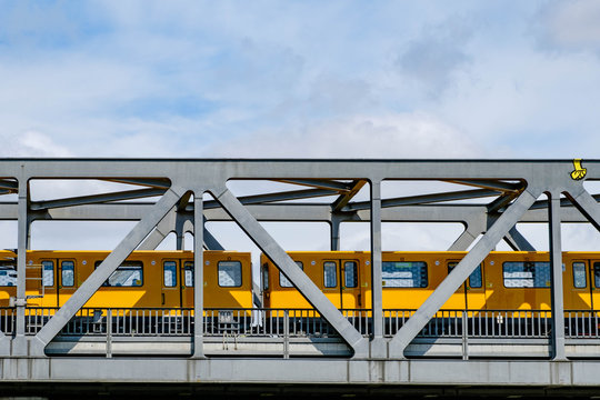 Berlin subway train (U-Bahn) crossing bridge  - Powered by Adobe