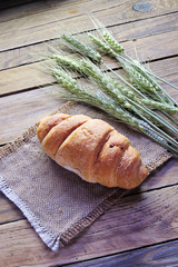 Croissant and spikelets of wheat