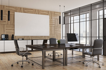 Meeting room interior with computer and poster