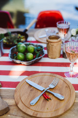 Fork and knife on plate with chilli on table