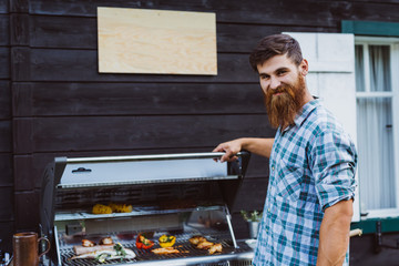 Man with long beard at barbecue gas station