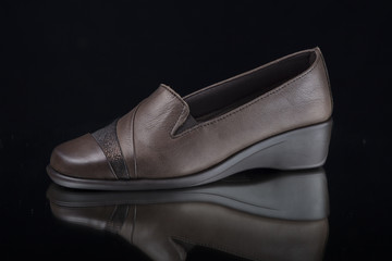 Female Brown Shoe on Black Background, Isolated Product, Top View, Studio.