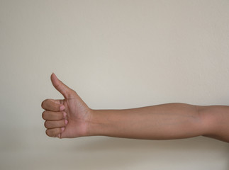 Hand with thumb up .