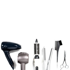 Various hair styling devices on white background, top view