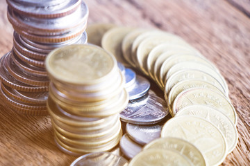 Row of coins on wood background for finance and Saving concept,Investment, Economy, Soft focus and...