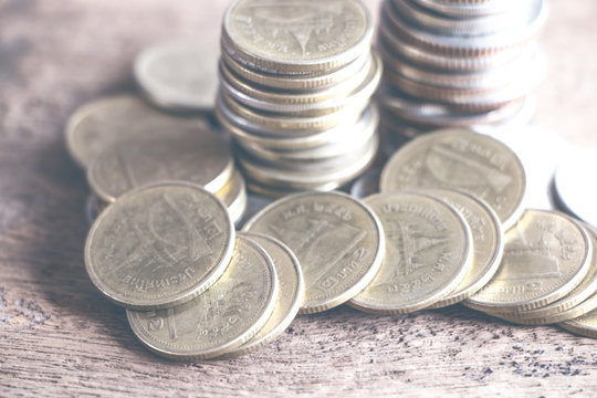 Row of coins on wood background for finance and Saving concept,Investment, Economy, Soft focus and dark style.