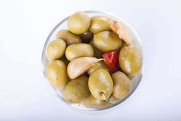 Bowl of homemade olives on a glass, typical spanish tapa, isolated on white background
