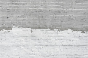Fototapeta premium Thin layer of plaster on a brick wall. White and gray plaster wall texture. Empty background