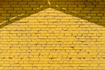 Yellow brick wall texture with roof shadows