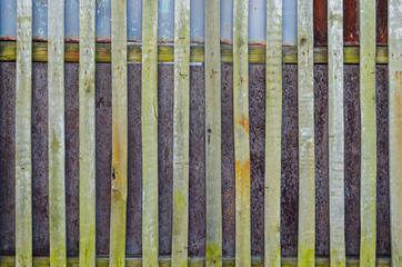 Old fence background. Wooden boards and rusty steel sheets