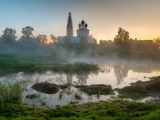 Misty morning overlooking the Kazan Church and the Church of St. John the Warrior in the village of Osenevo, Gavrilov-yamskiy district of the Yaroslavl region
