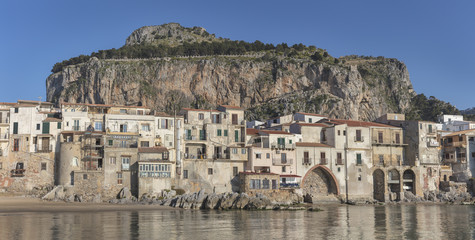 Old medieval town Cefalu with mountain La Rocca in background, Sicily, Italy