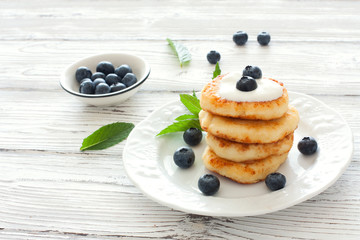 Delicious cottage cheese pancakes or syrniki with fresh blueberry