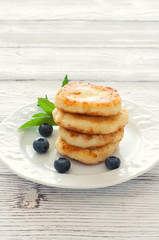Delicious cottage cheese pancakes or syrniki with fresh blueberry