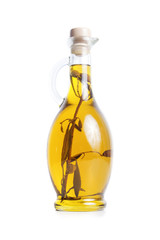 Olive oil in a jug with olive branch inside